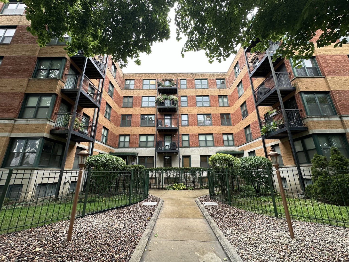 a view of a brick building next to a yard