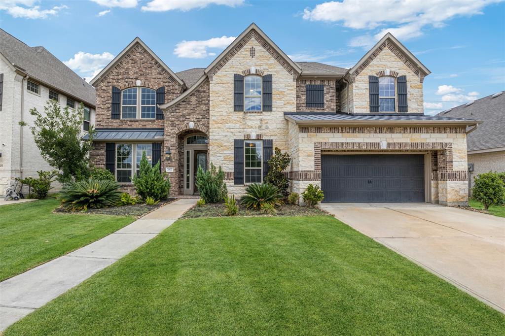 a front view of a house with a yard and garage