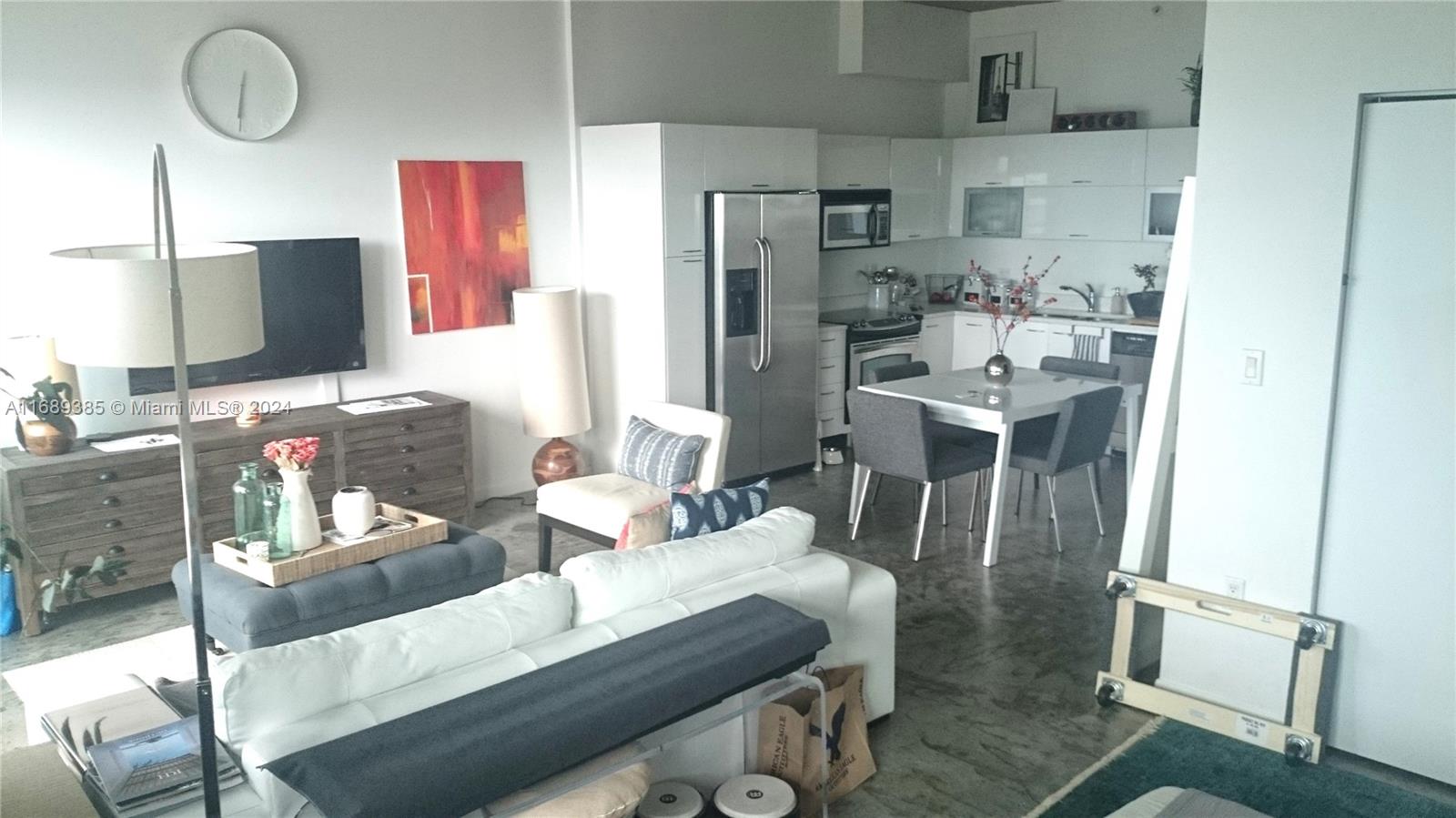 a dining room with furniture and a flat screen tv