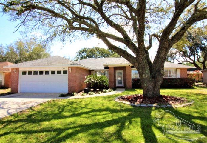 a front view of house with yard and trees