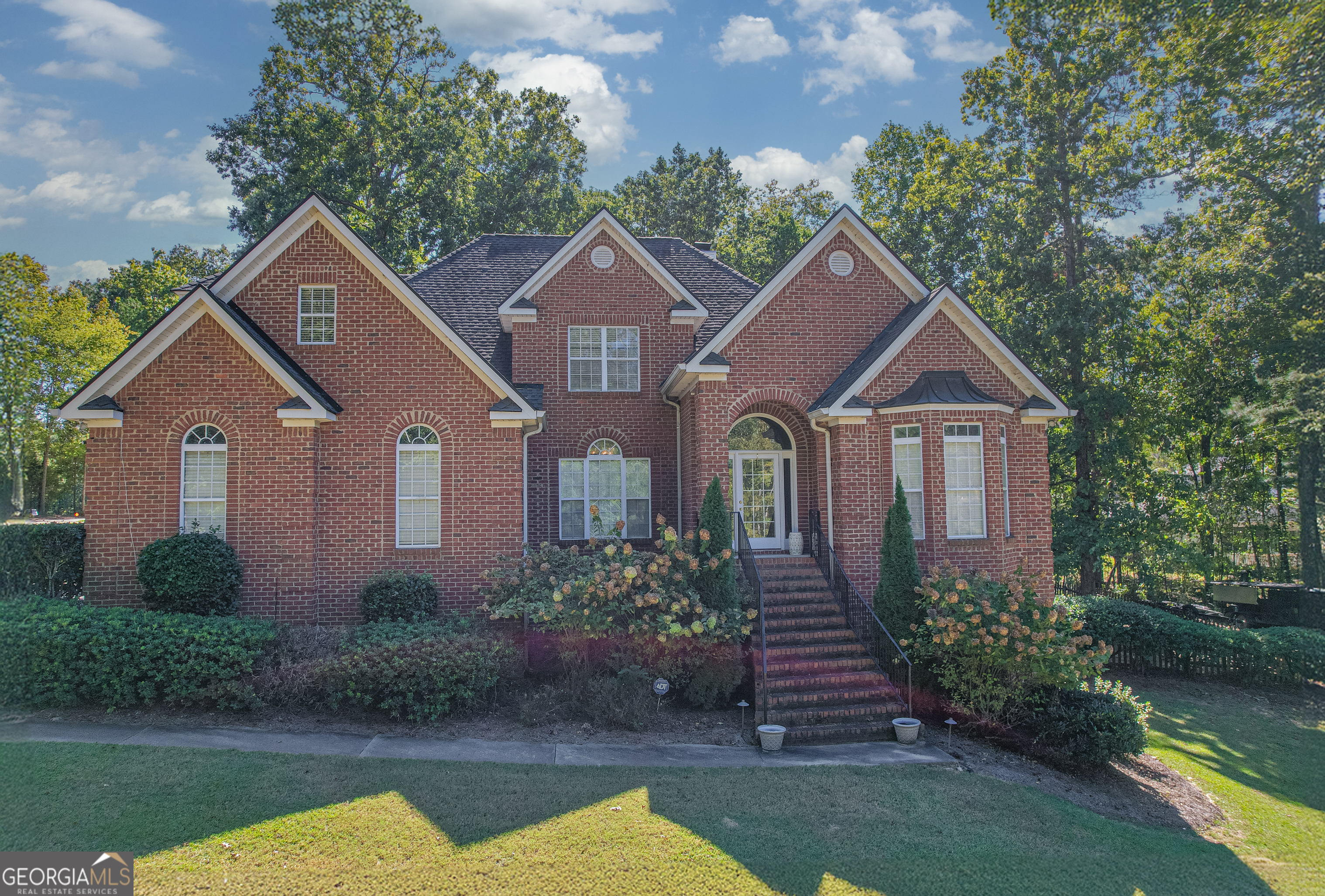 a front view of a house with garden