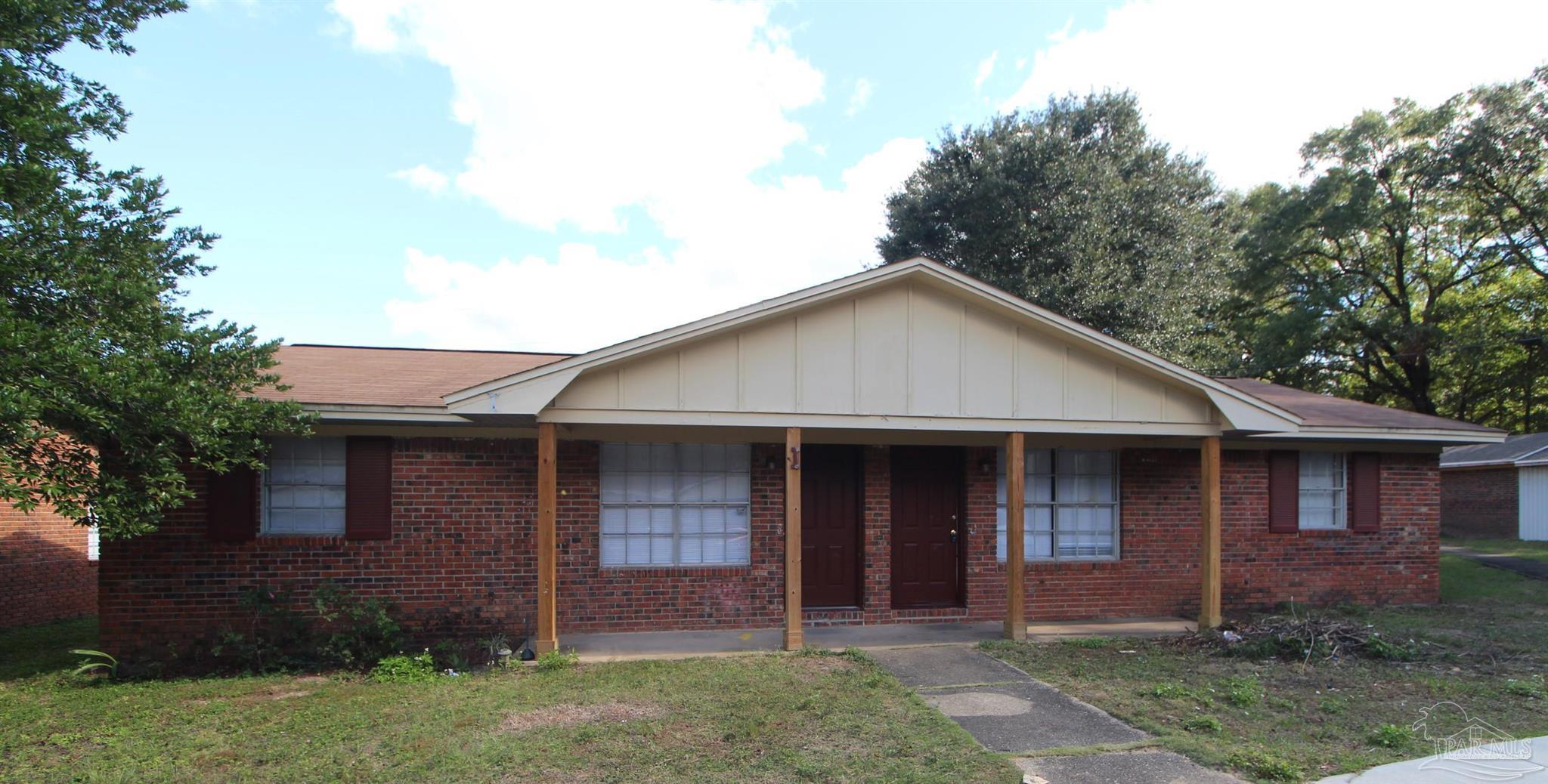 front view of brick house with a yard