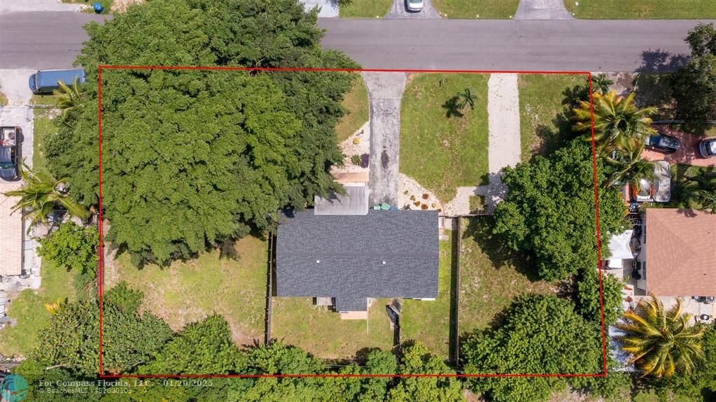 an aerial view of a house with a yard outdoor seating and garden