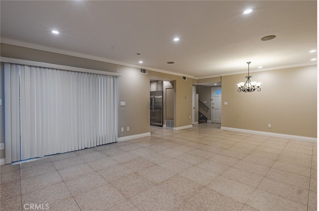 an empty room with kitchen and closet area