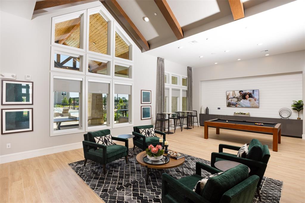 a living room with furniture and large windows