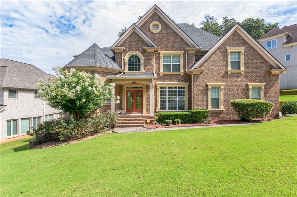 a front view of a house with a yard