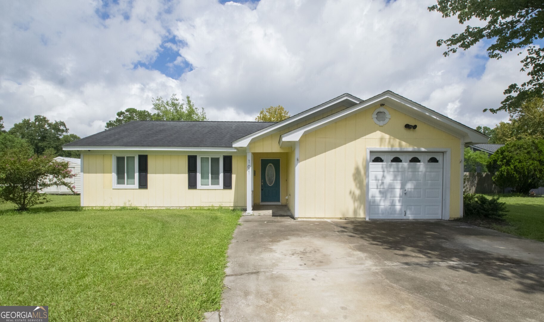 a front view of a house with garden