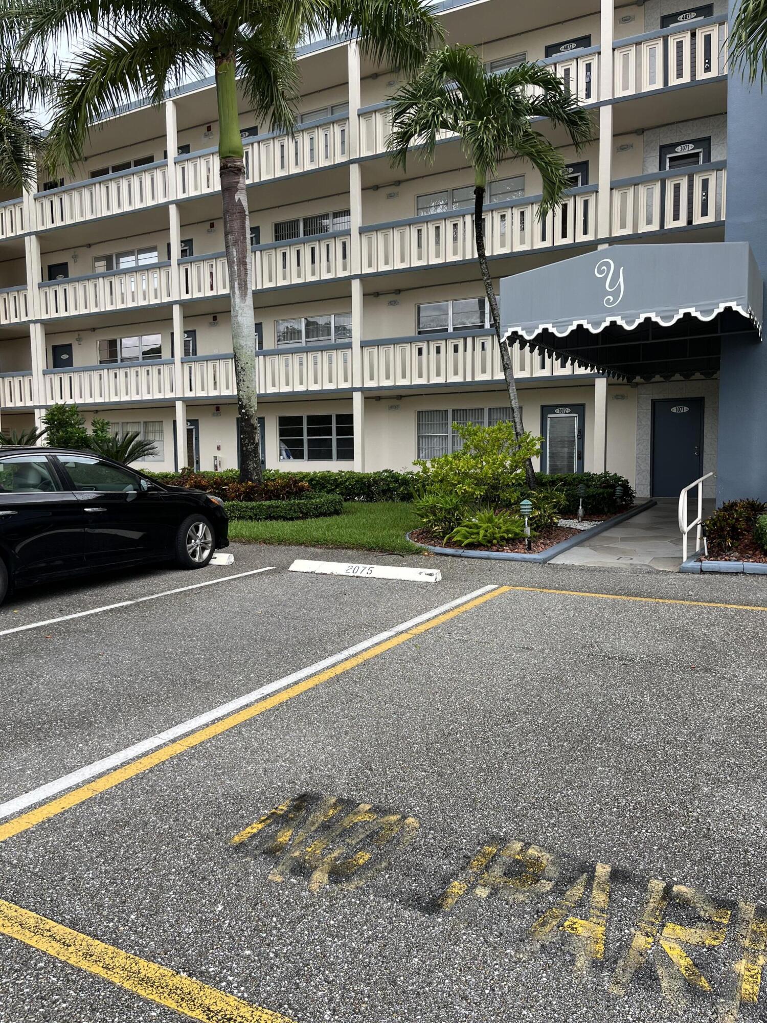 a couple of cars parked in front of a building