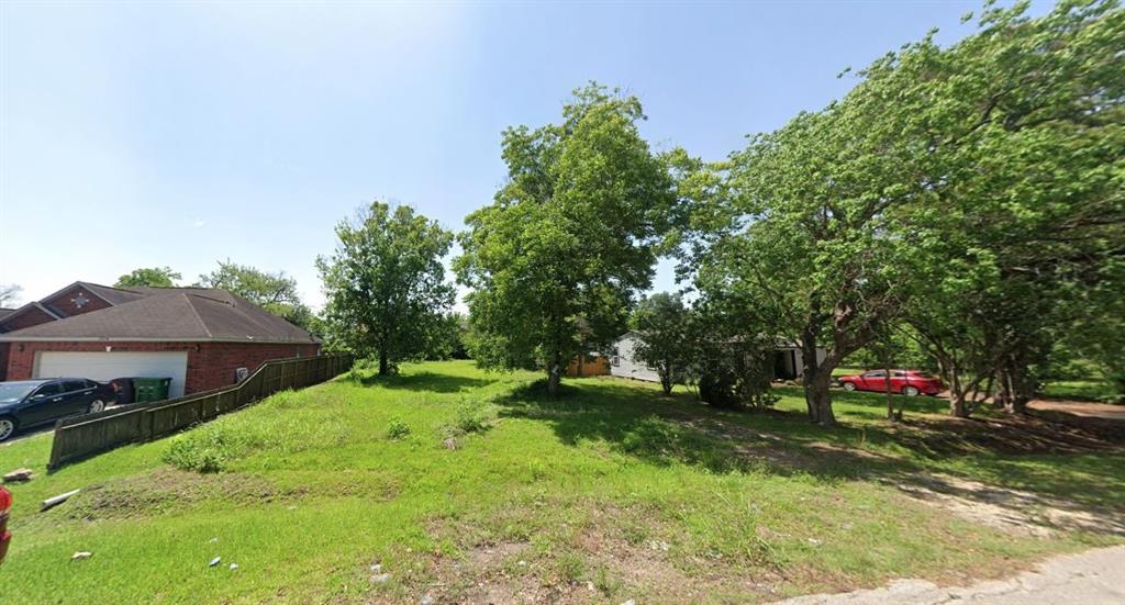 a green field covered with tall trees