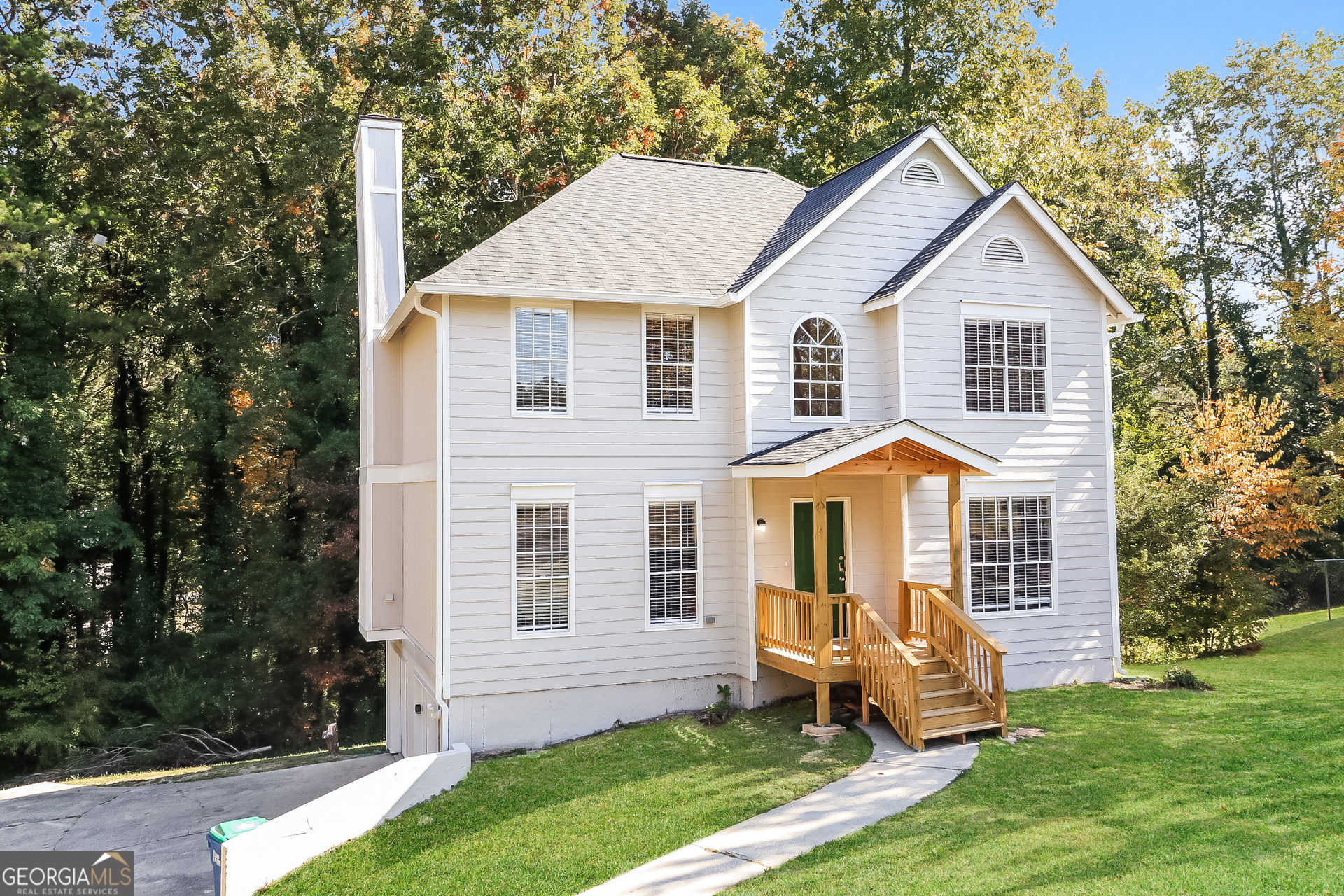 a front view of a house with a yard and fence