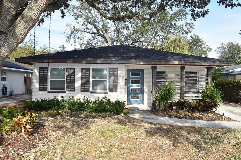 a front view of a house with garden and porch