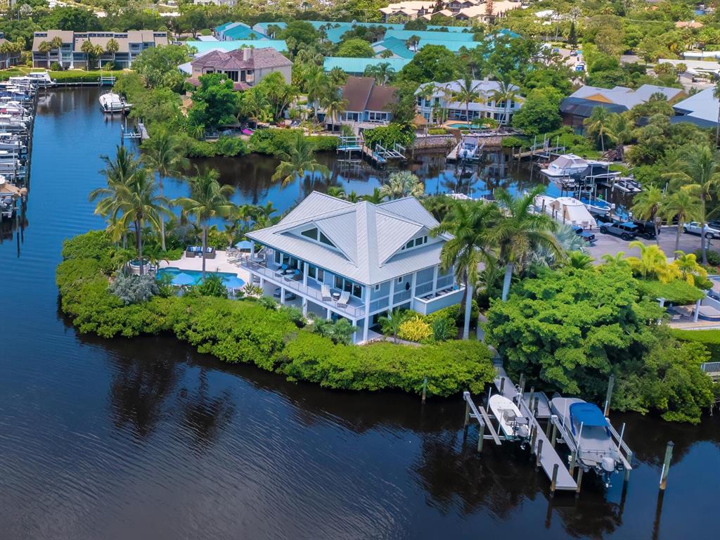 an aerial view of a house with garden space and lake view