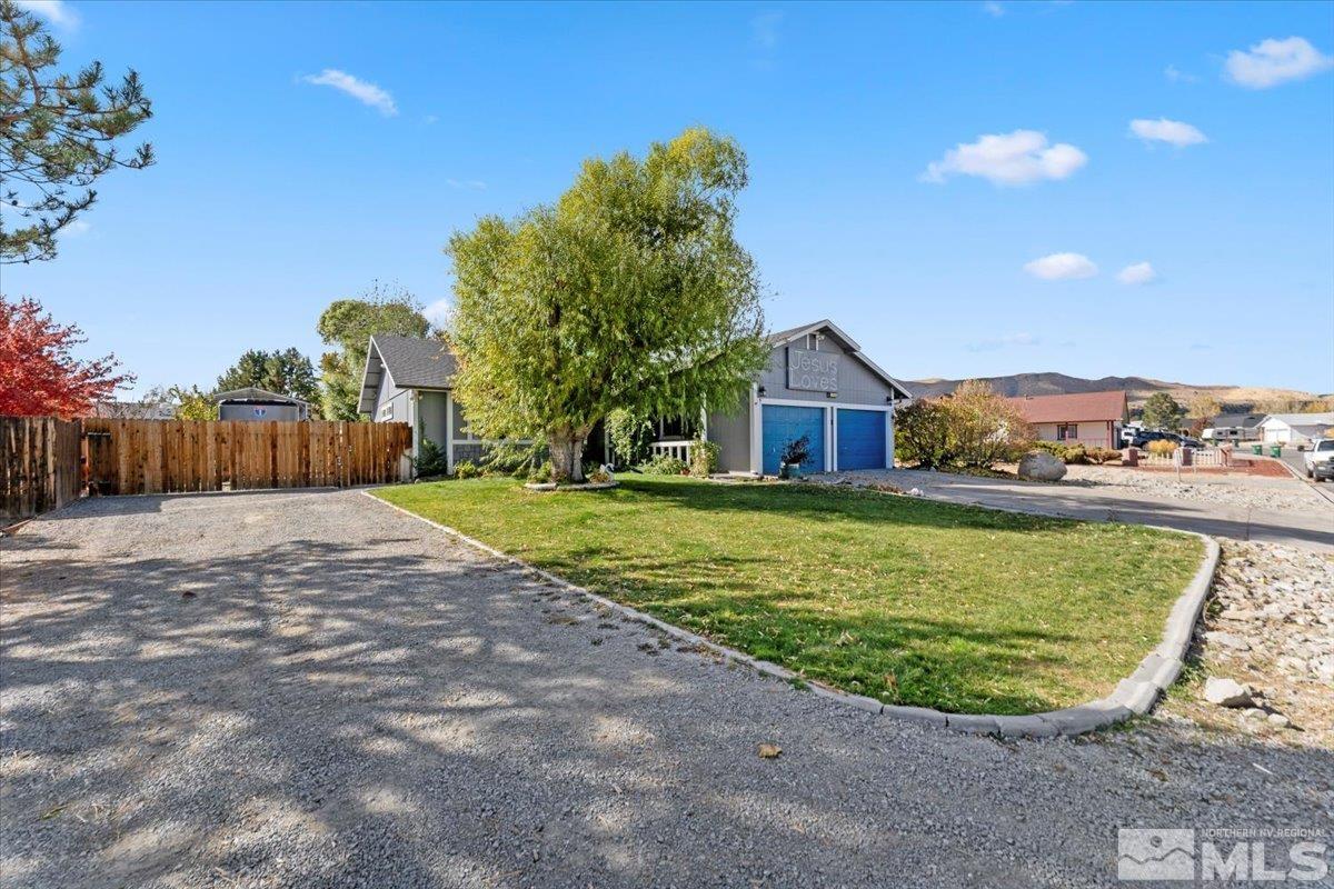 a view of a house with a backyard