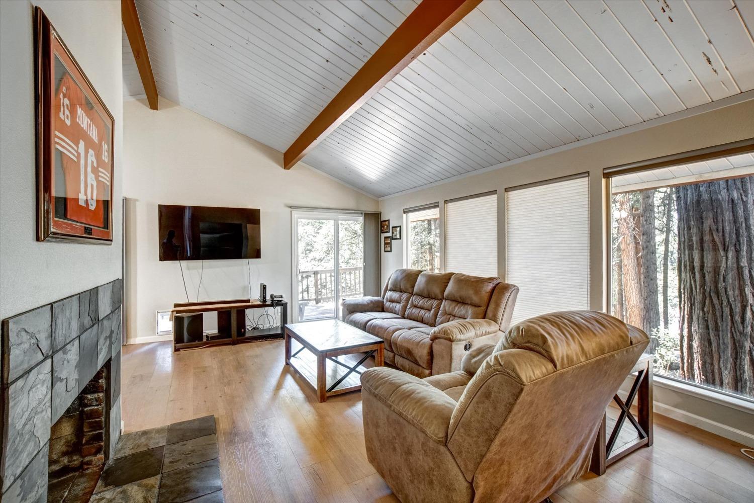 a living room with furniture fireplace and flat screen tv