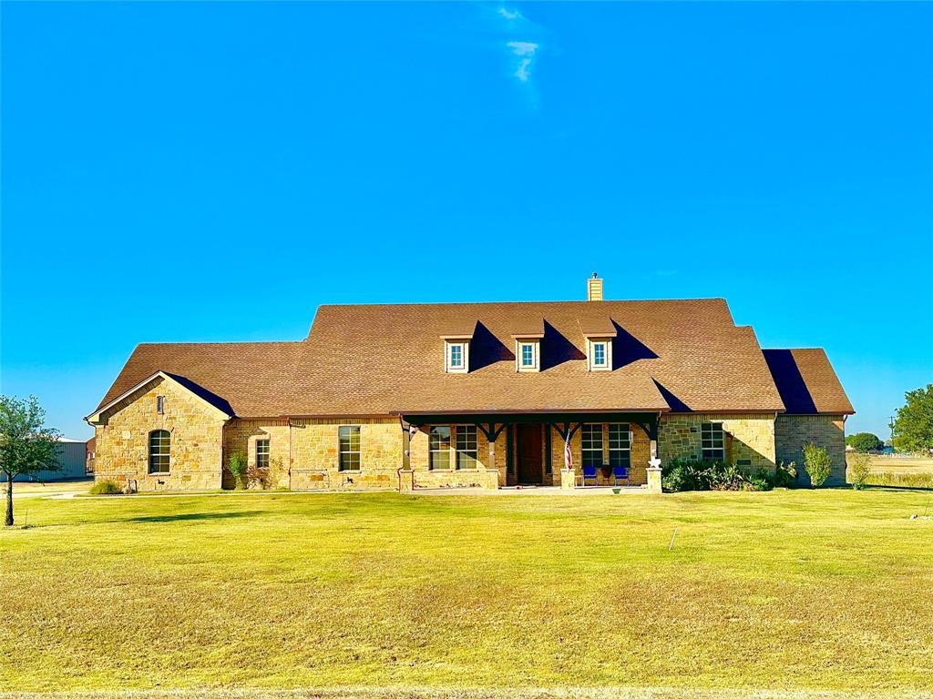 a front view of a house with a big yard