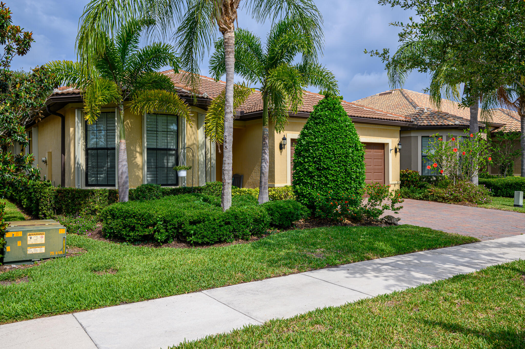 a front view of a house with a garden