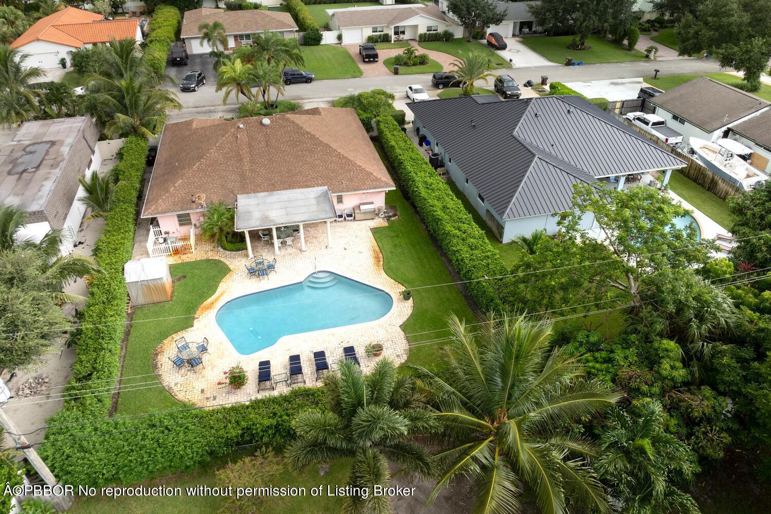 an aerial view of a house with yard swimming pool and outdoor seating