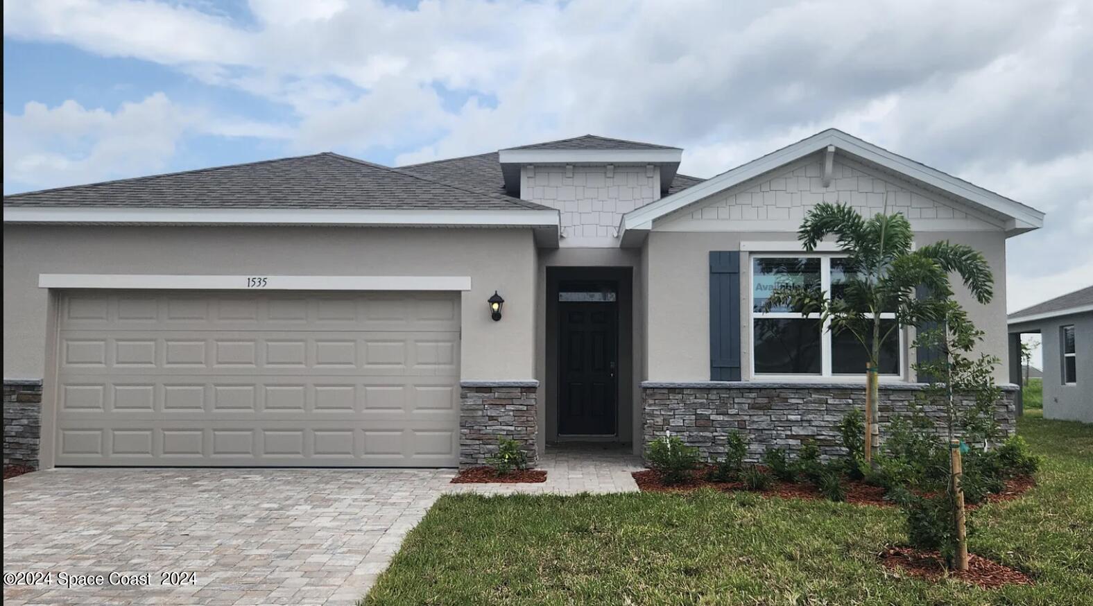 a front view of a house with garage