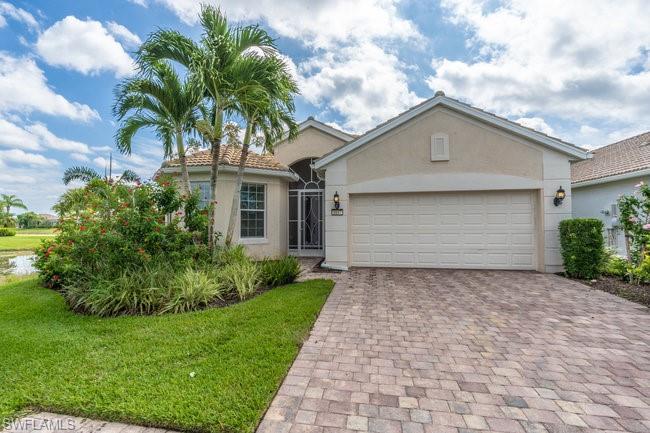 View of front of property featuring a garage and a front yard