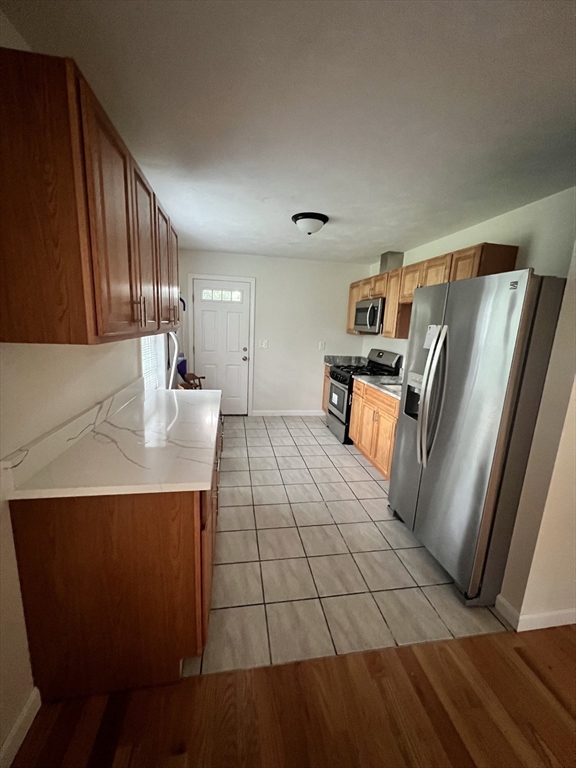 a kitchen with stainless steel appliances a refrigerator and a counter top space