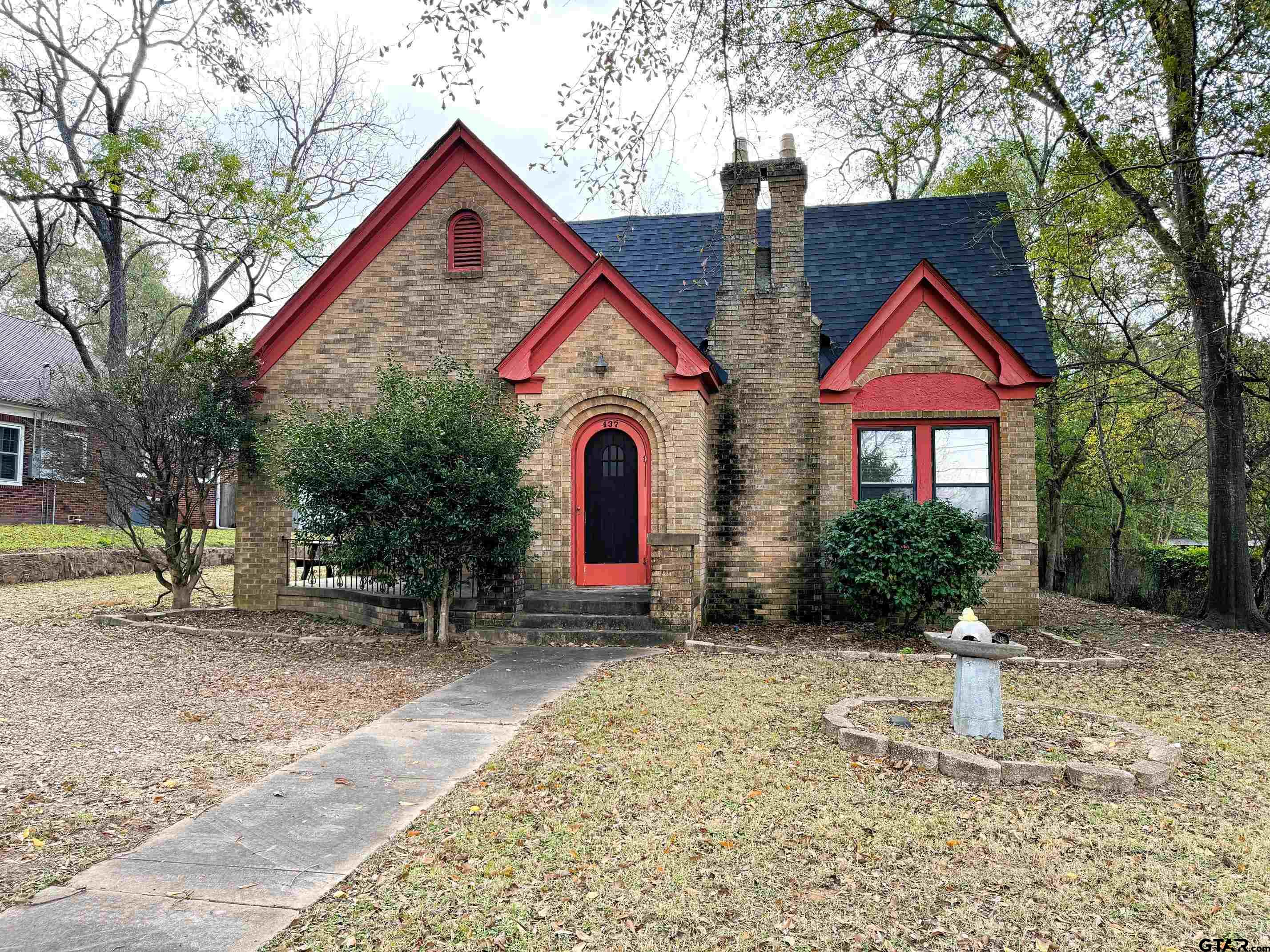 a front view of a house with garden