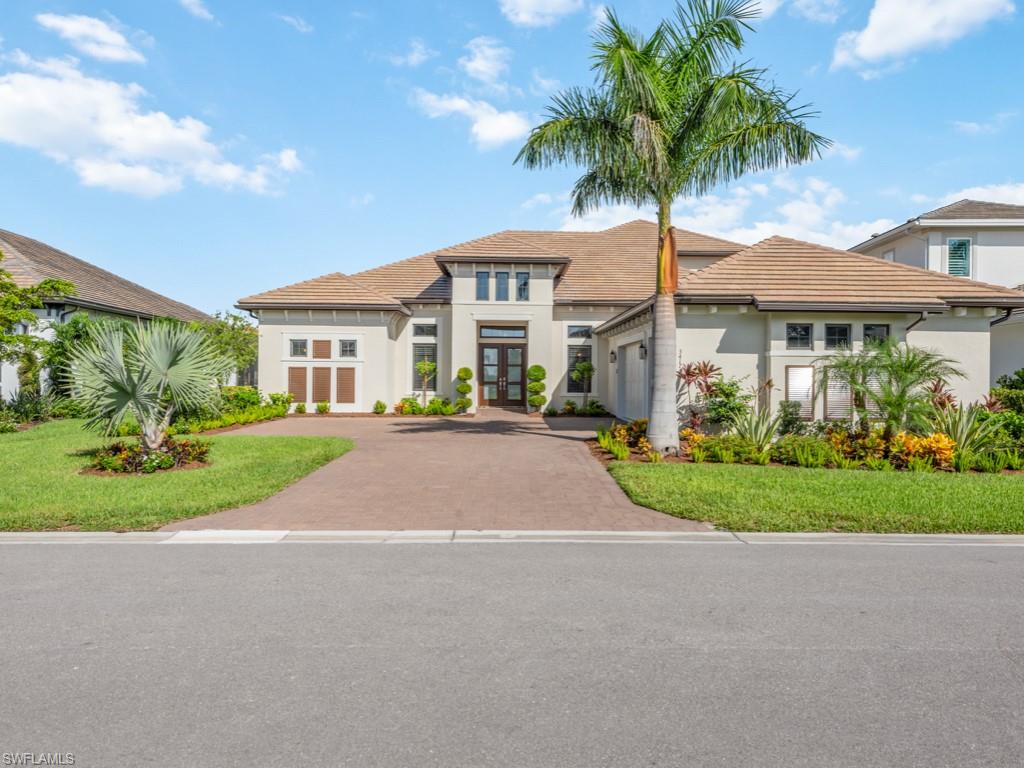 a front view of a house with a garden and yard