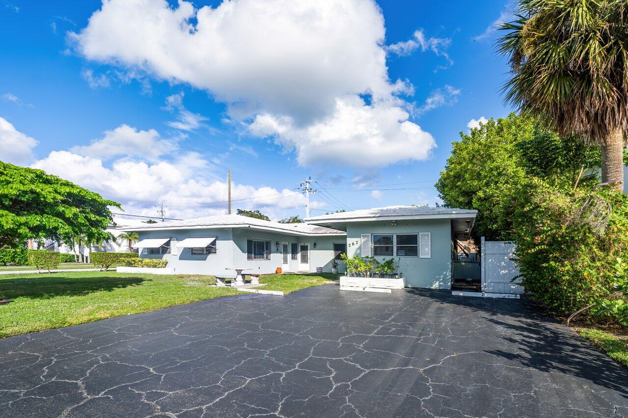 a view of house with outdoor space and swimming pool