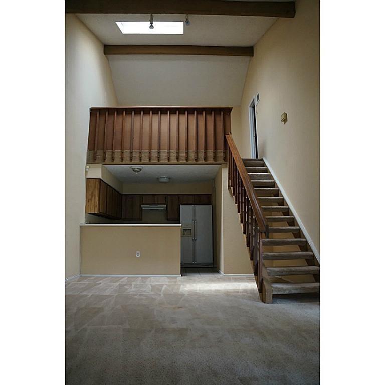 a view of a hallway with stairs