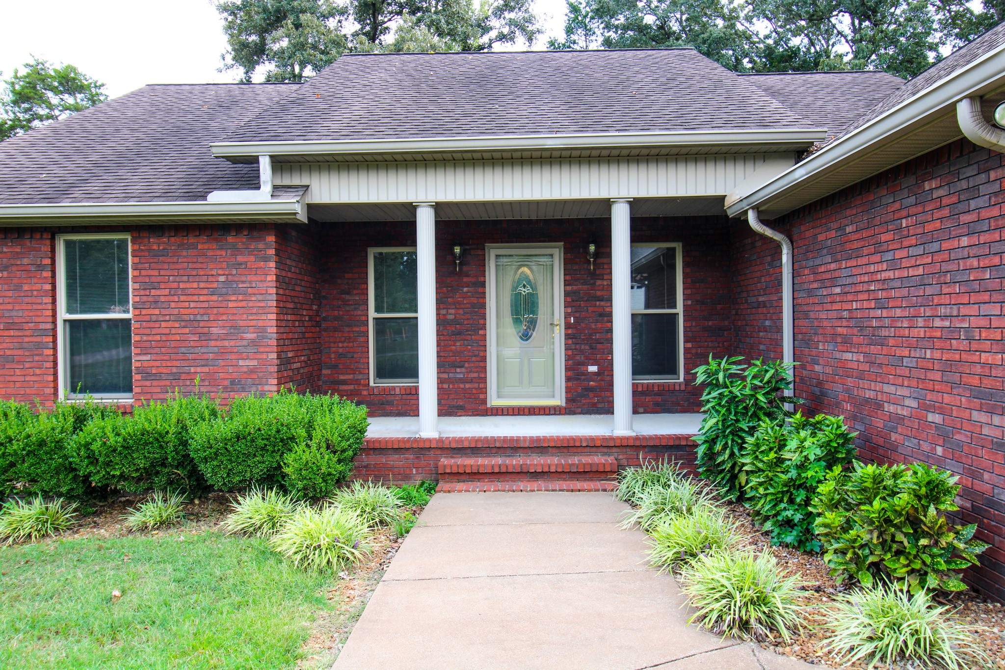 a front view of a house with garden