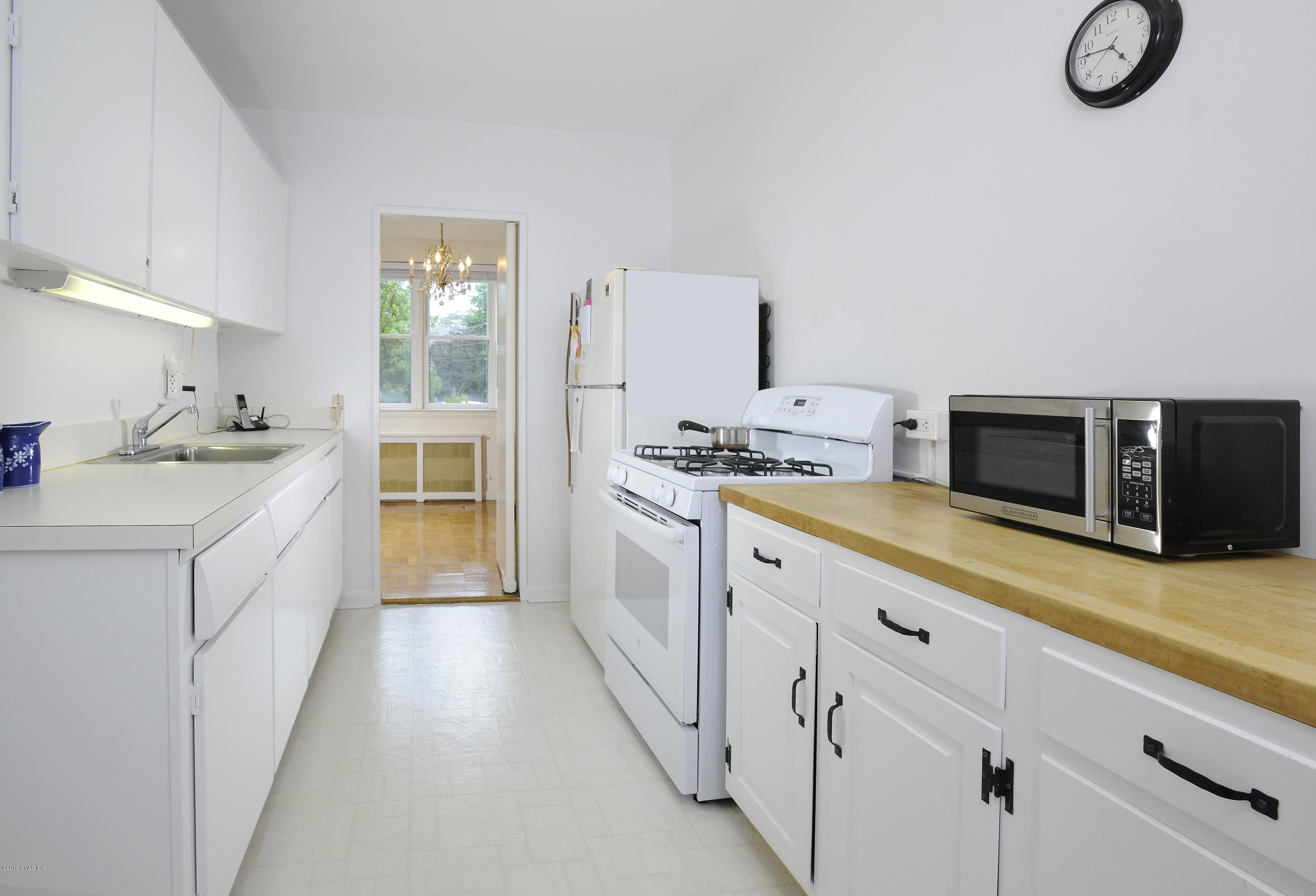 a kitchen with granite countertop a sink and a stove top oven