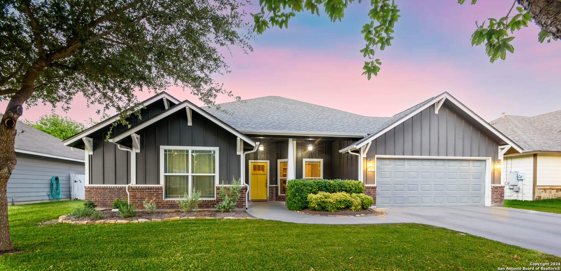 a front view of a house with a yard and porch