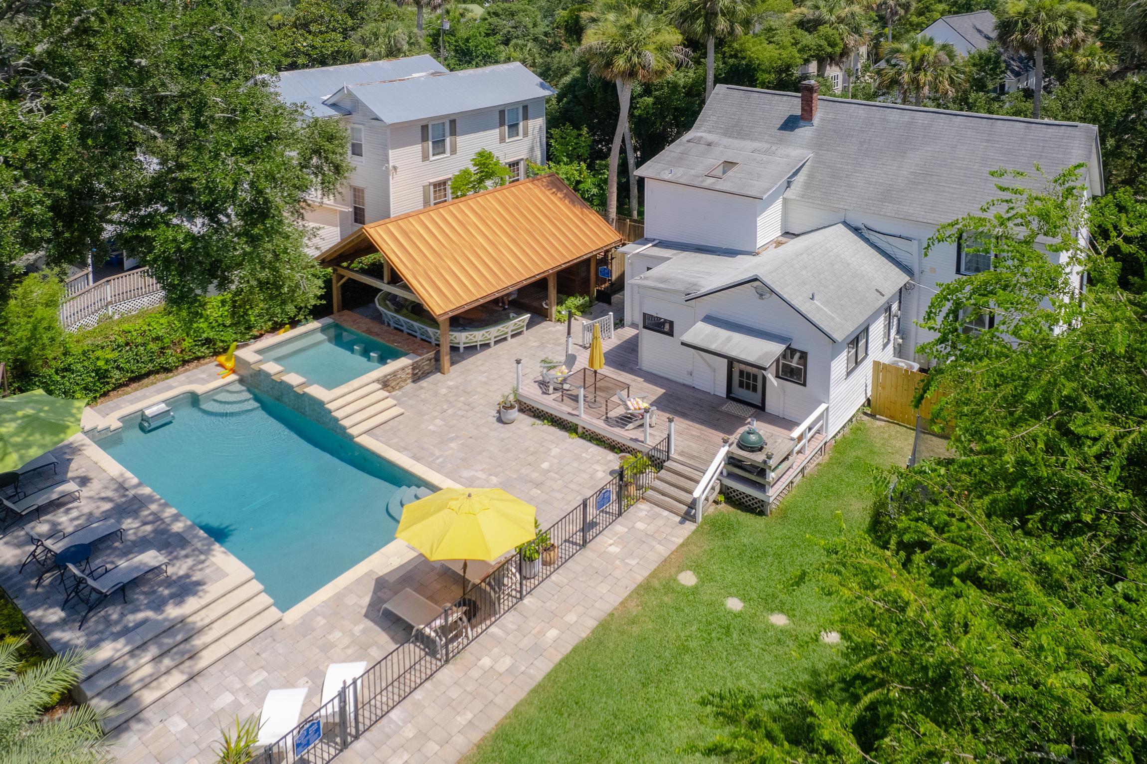 an aerial view of a house with garden space and street view