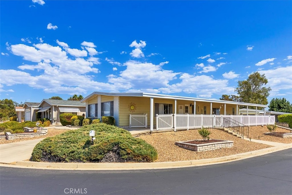 a view of a house with a swimming pool and a yard