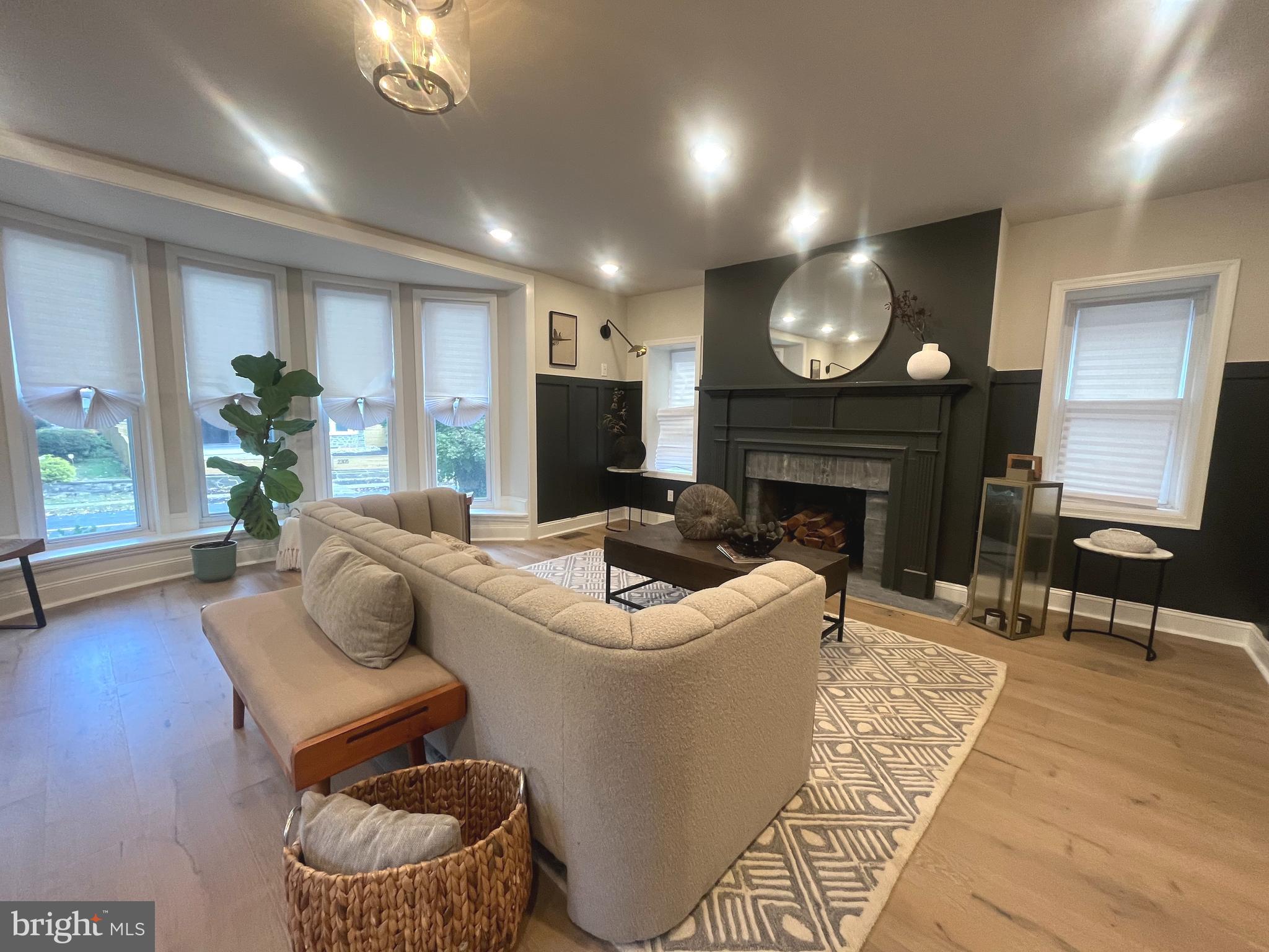 a living room with furniture a fireplace and a flat screen tv