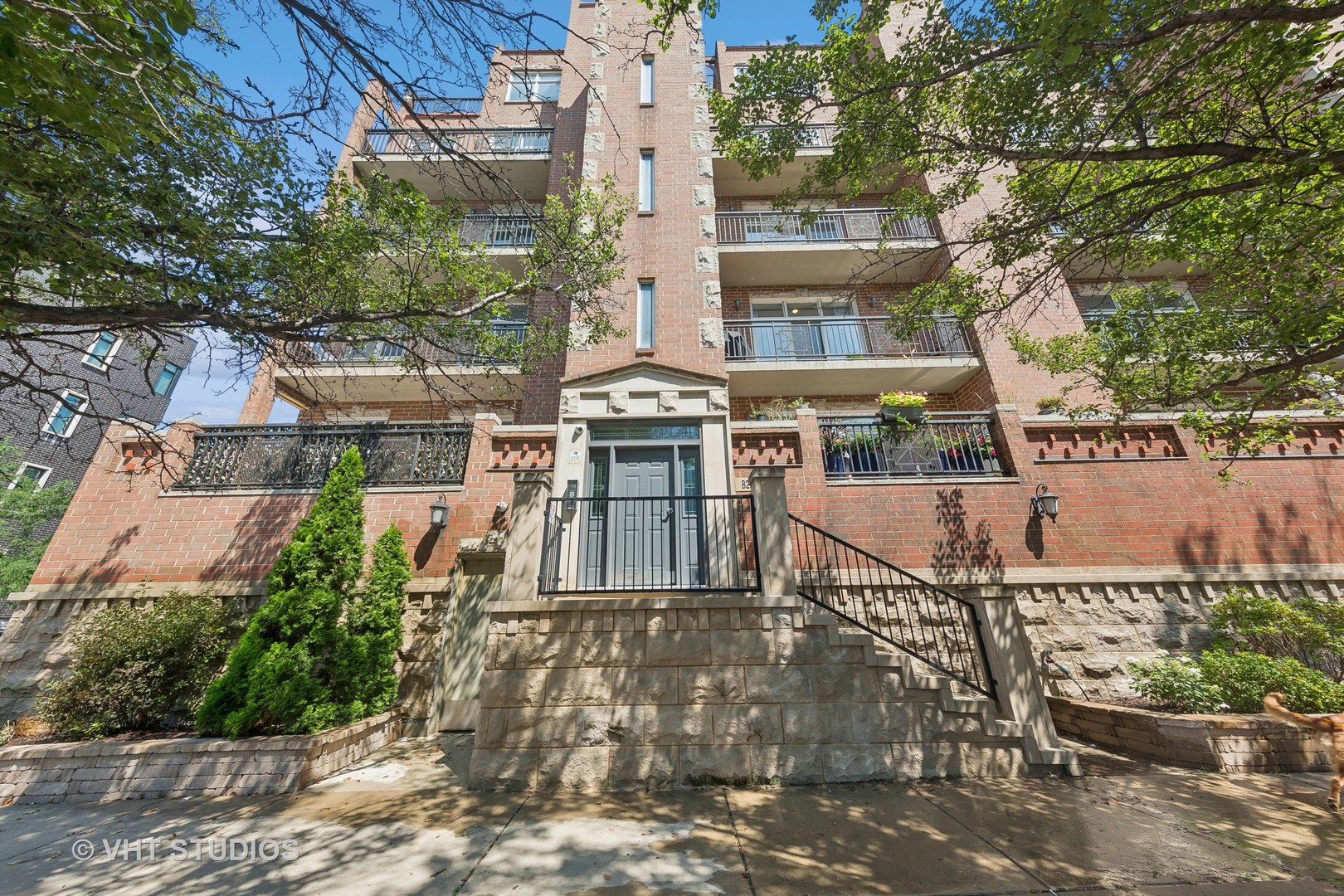 front view of a building with a garden