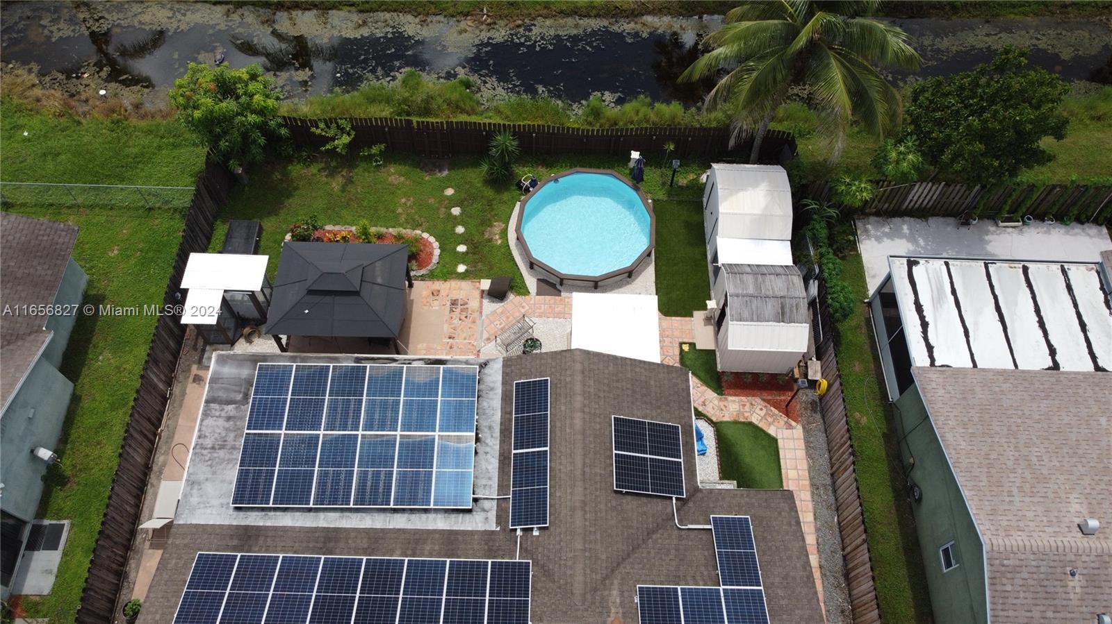 an aerial view of houses with outdoor space and lake view