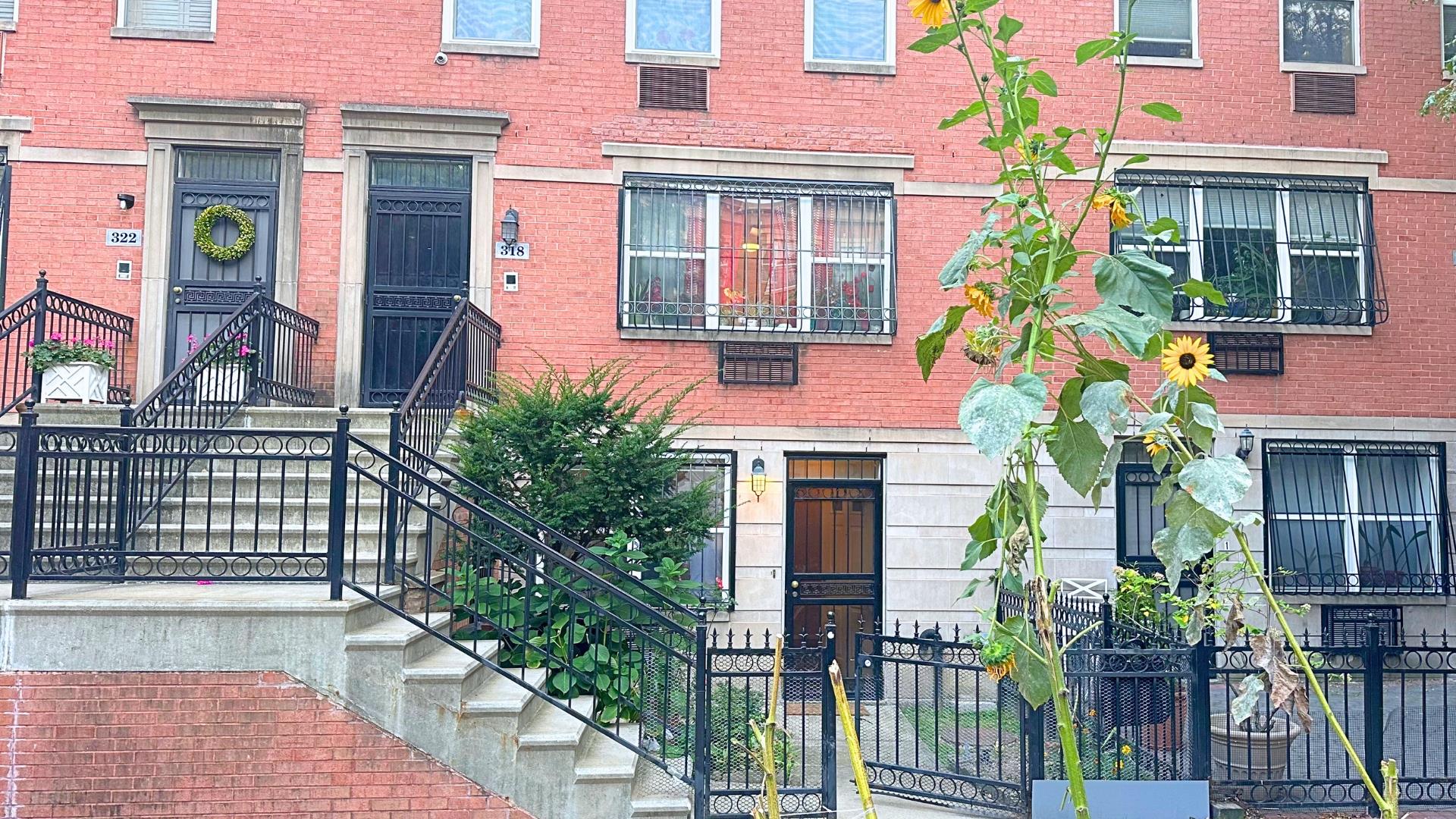 a front view of a multi story residential apartment building with a yard