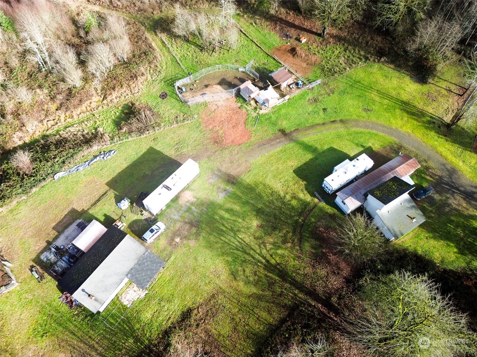 an aerial view of a house with a yard and lake view