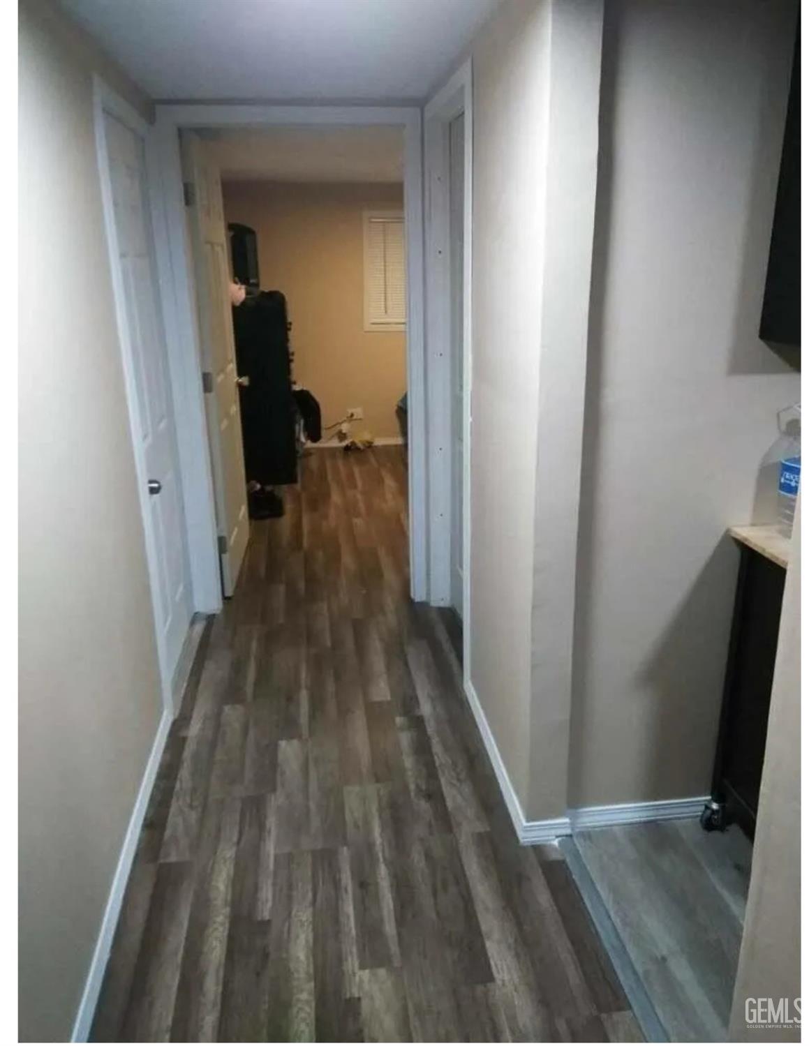 a view of a hallway with wooden floor and staircase