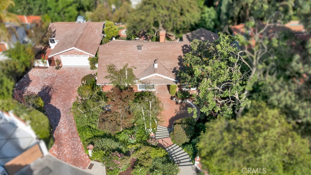 an aerial view of a house with a yard and garden