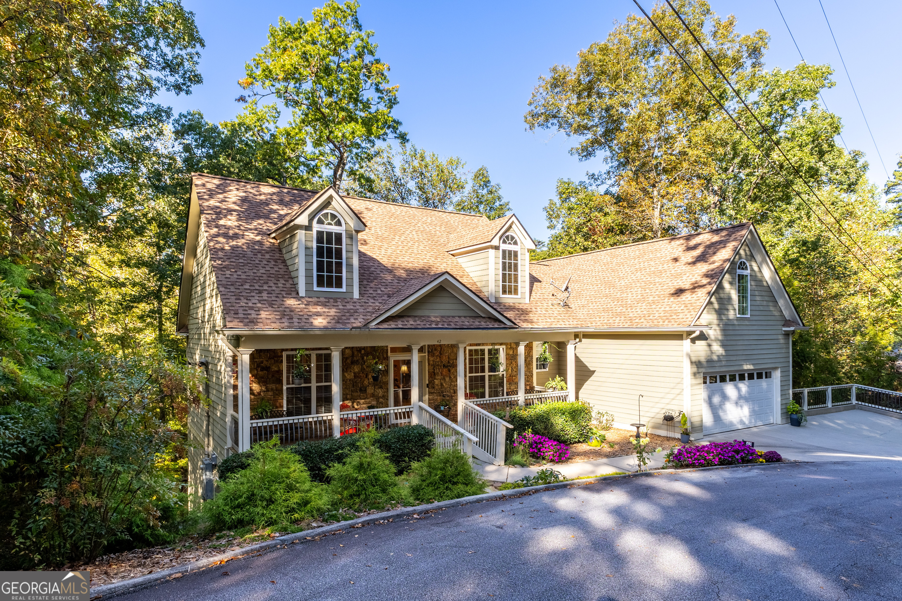 a front view of a house with a garden