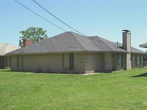 a front view of a house with a garden and yard