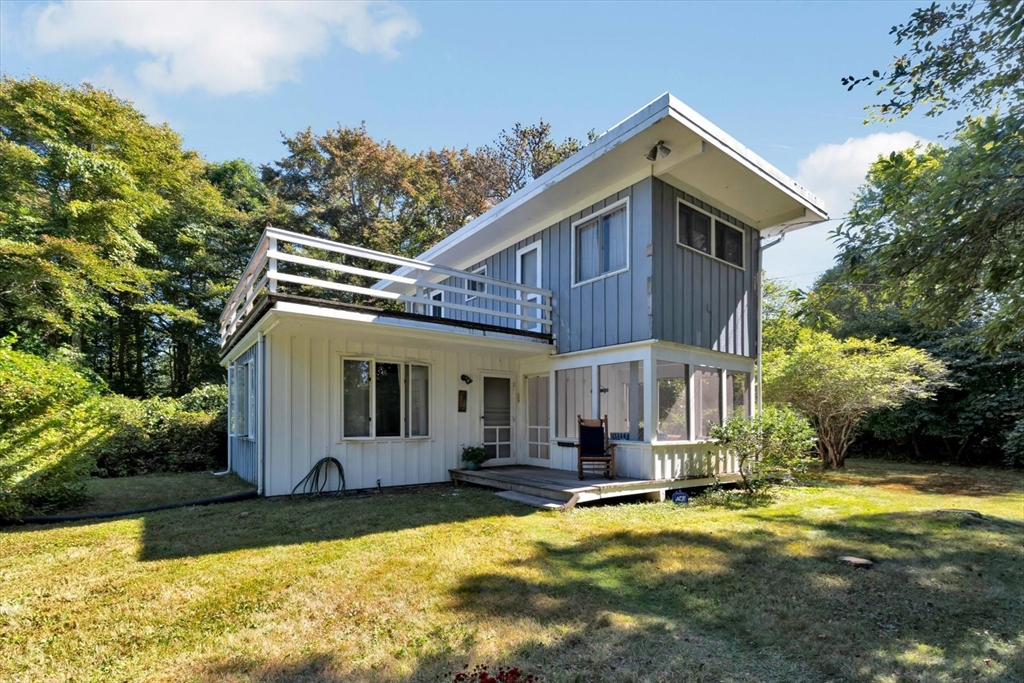 a view of a house with swimming pool and sitting area