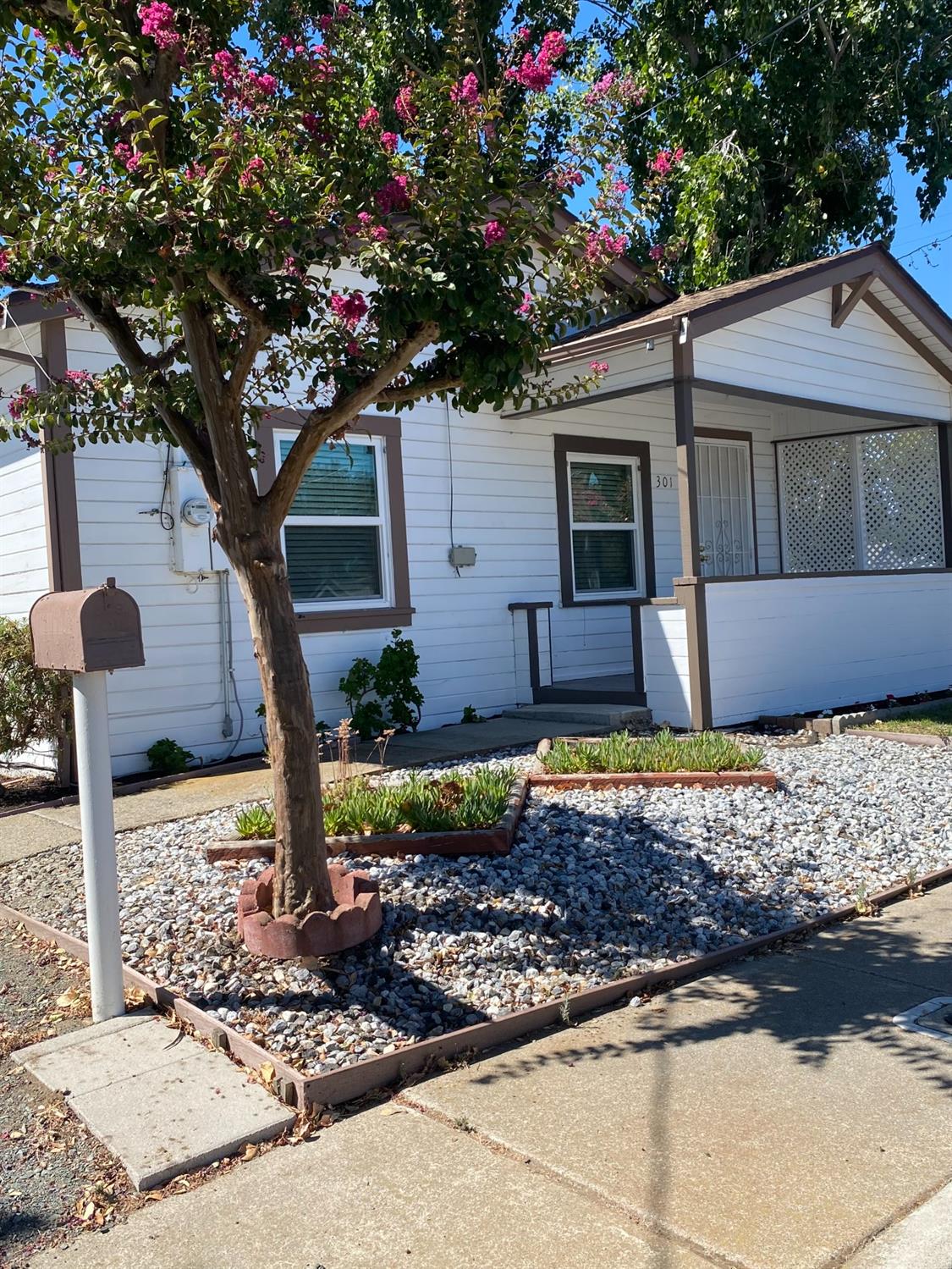 a front view of a house with garden