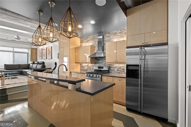 a kitchen with stainless steel appliances granite countertop a sink refrigerator and cabinets