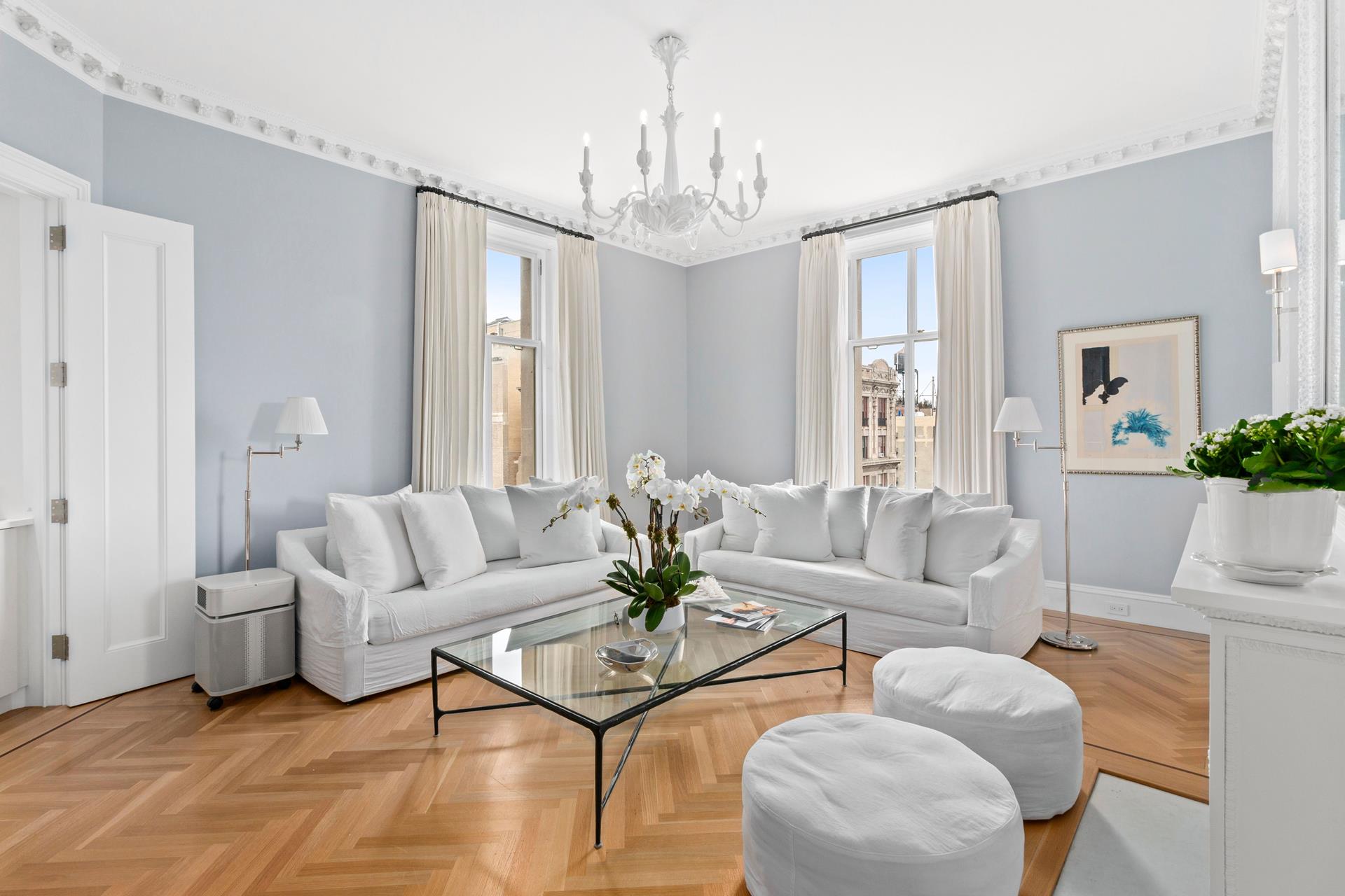 a living room with furniture a chandelier and a chandelier