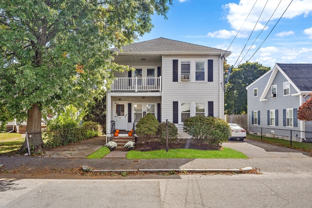 a front view of house with yard and green space