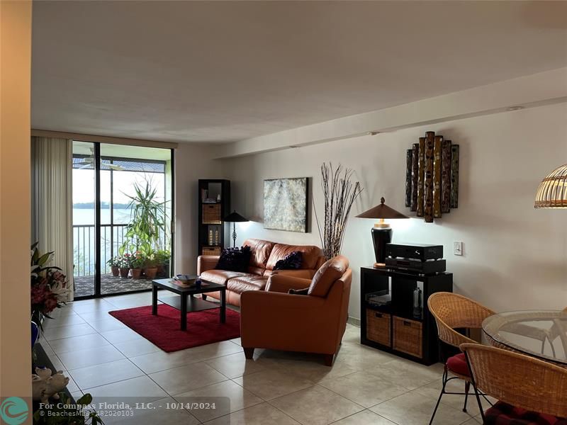 a living room with furniture rug and wooden floor