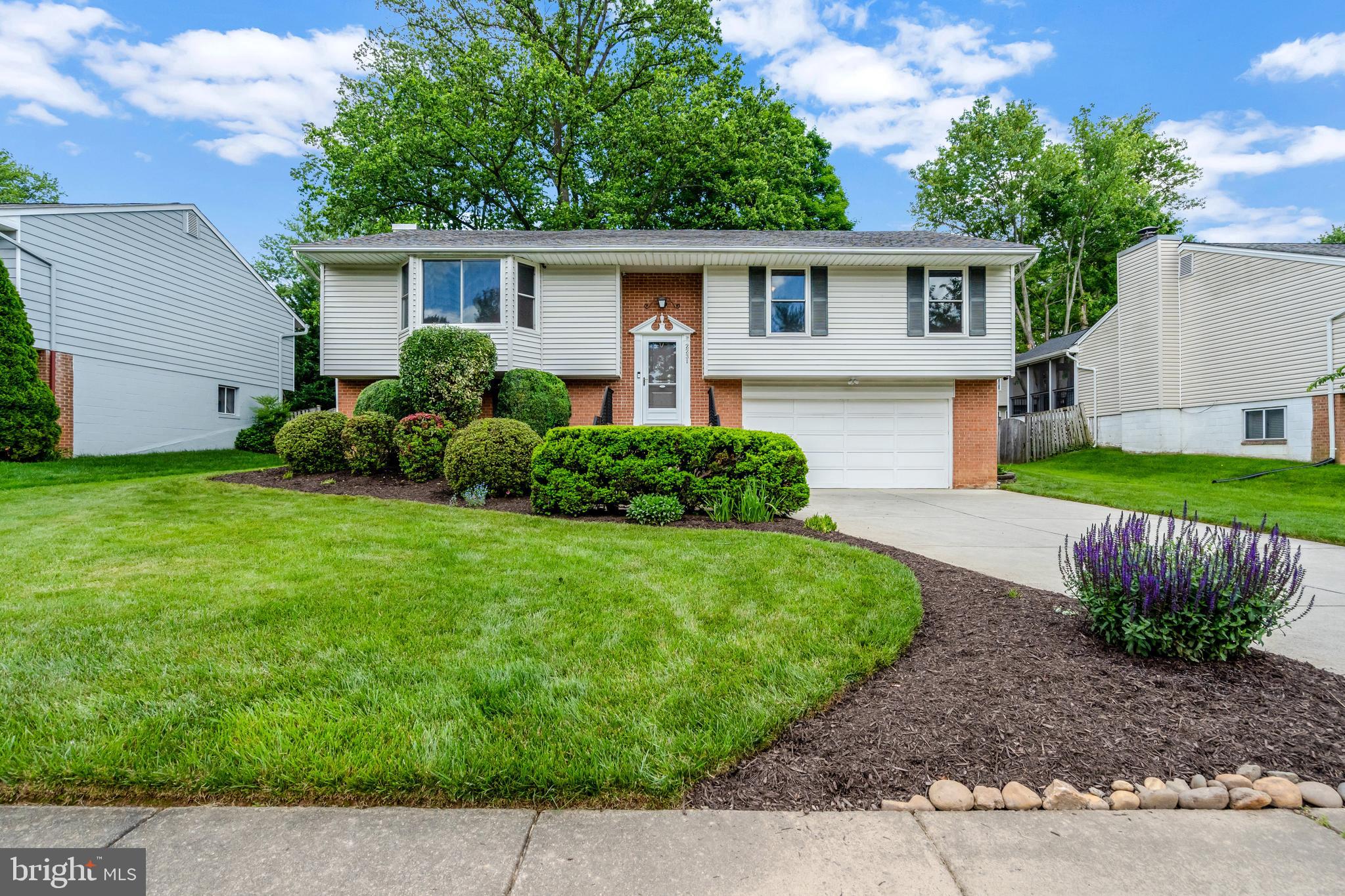 a view of a house with a yard and a garden