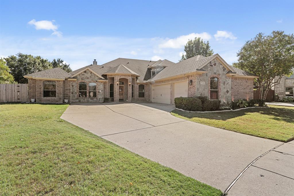 a front view of a house with a garden and yard